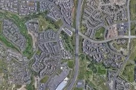 Aerial view of a suburban area with roads and houses.