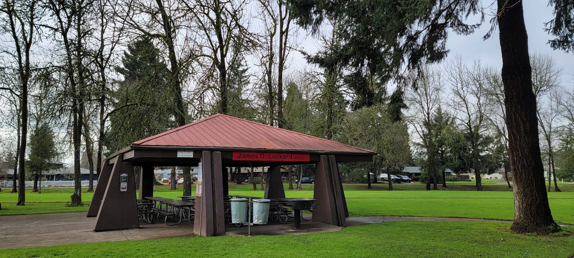 A park shelter labeled "James D. Lockard," surrounded by trees and grassy areas.