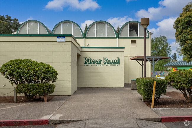 Exterior of the River Road Park and Recreation District building with green accents and arched windows.