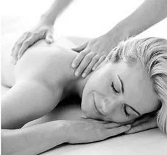 A black and white photo of a woman receiving a back massage.