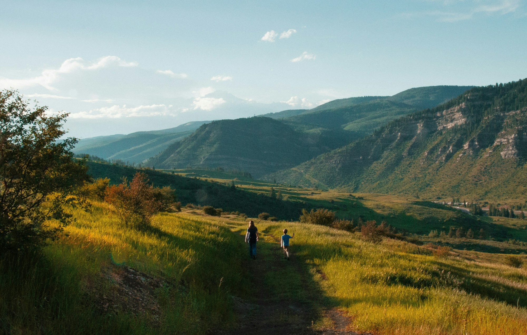 Two people hiking on a mountain trail