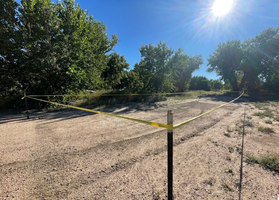 A newly reseeded area at Confluence Park in Pueblo, CO, marked with yellow caution tape.