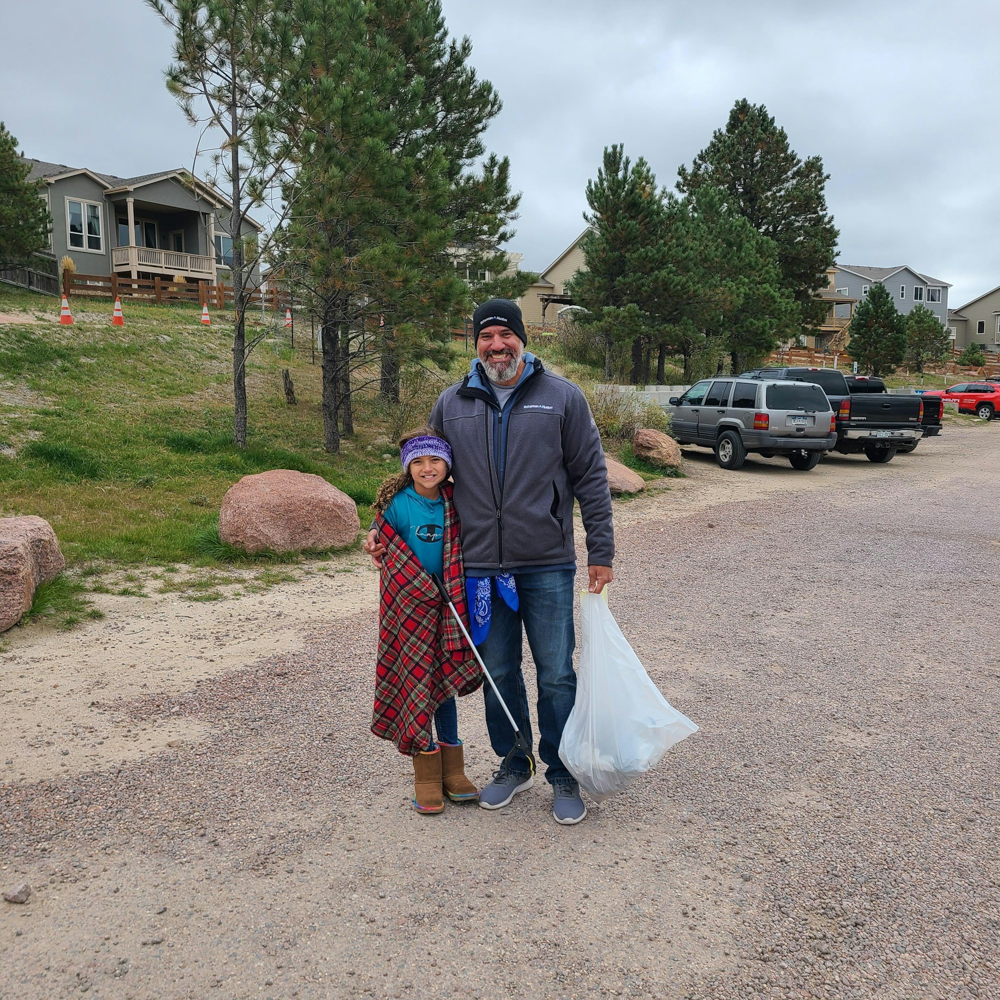 May contain: architecture, building, outdoors, shelter, clothing, dress, pants, face, head, person, photography, portrait, neighborhood, plant, tree, formal wear, pickup truck, transportation, truck, vehicle, hat, fashion, gown, wedding, wedding gown, car, footwear, shoe, skirt, accessories, bag, handbag, adult, male, man, path, city, road, street, and urban