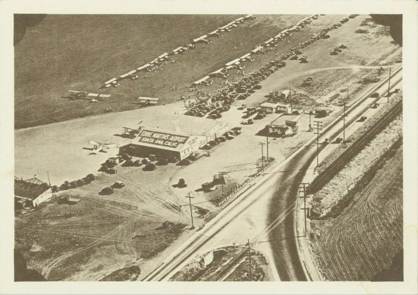 An aerial view of a vintage airport with planes and cars, labeled "Eddie Martin's Airport, Santa Ana, Calif."