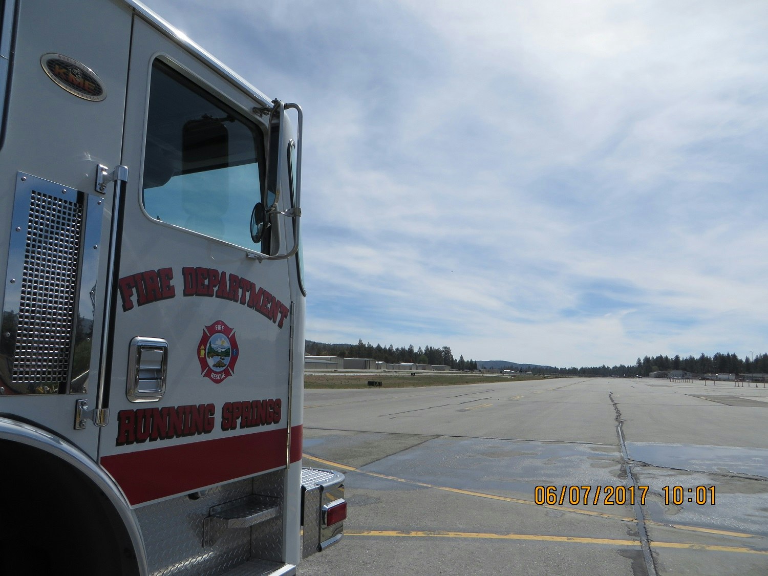 Fire truck from Running Springs Fire Department near an empty runway.