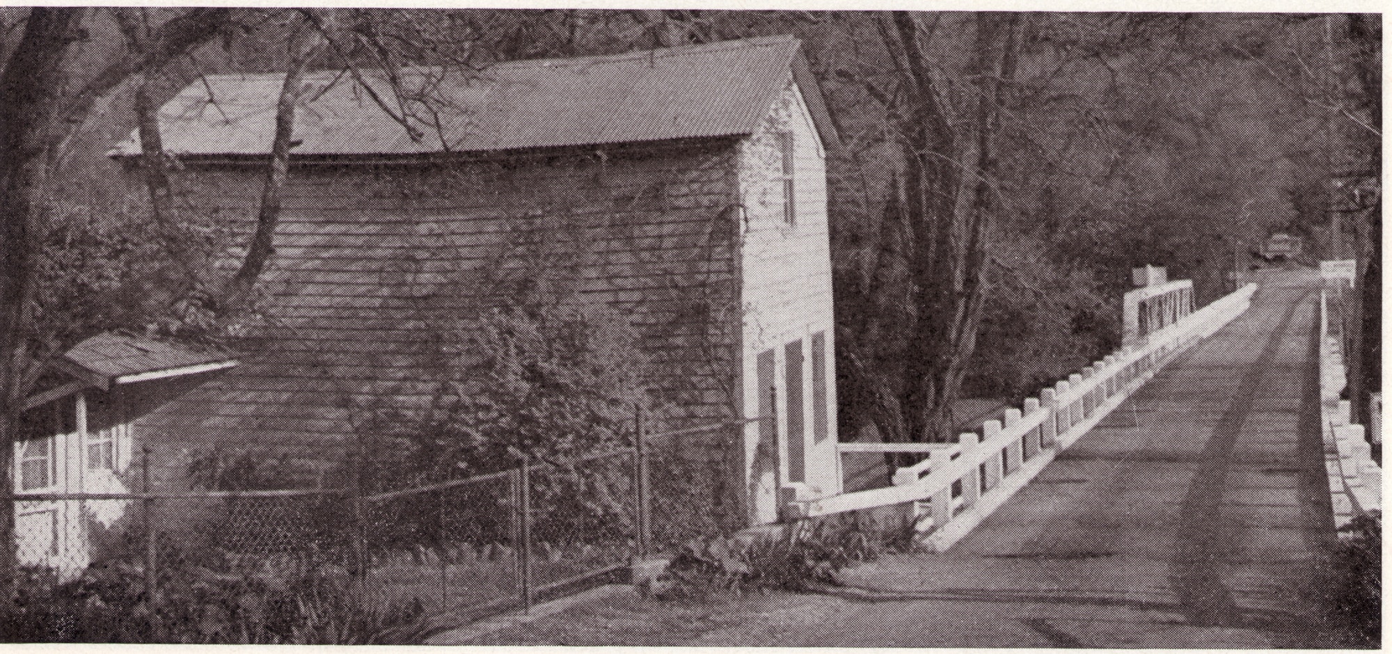 historic photo of town, bridge, house