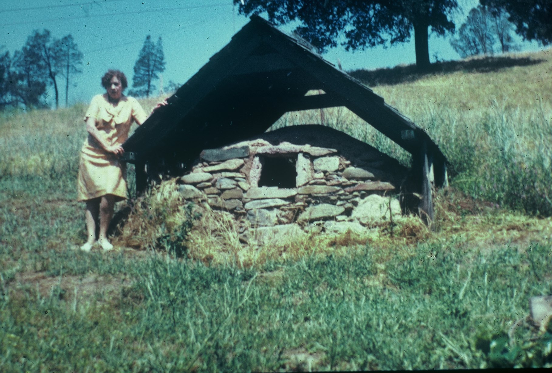 woman standing next to a well