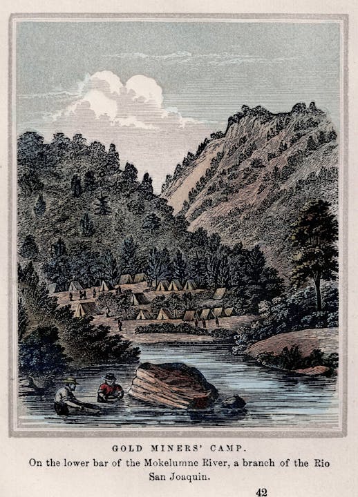 A gold miners' camp by a river, surrounded by tents and trees in a mountainous landscape.