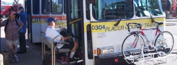 Man in a wheelchair boarding the bus using the bus lift