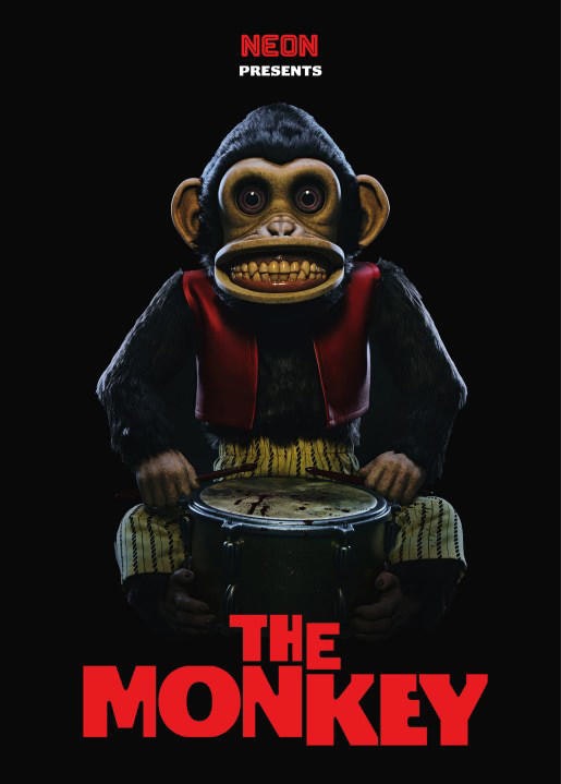 Toy monkey with cymbals, wearing a red vest and striped pants against a black background. Text reads "NEON Presents THE MONKEY."