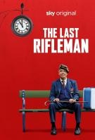 A seated elderly man in uniform on a bench, with text "The Last Rifleman" and a clock above, on a red background.