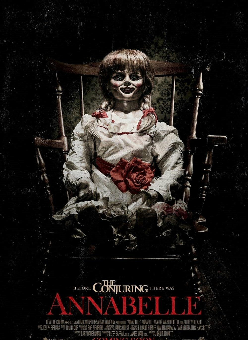 A creepy doll in a chair, promoting the movie "Annabelle." The text reads, "Before The Conjuring, there was Annabelle."