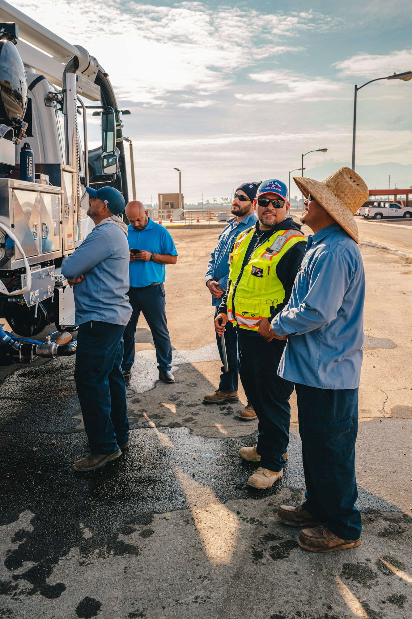 May contain: person, worker, clothing, footwear, shoe, hat, accessories, glasses, adult, male, man, pants, wristwatch, hardhat, and helmet