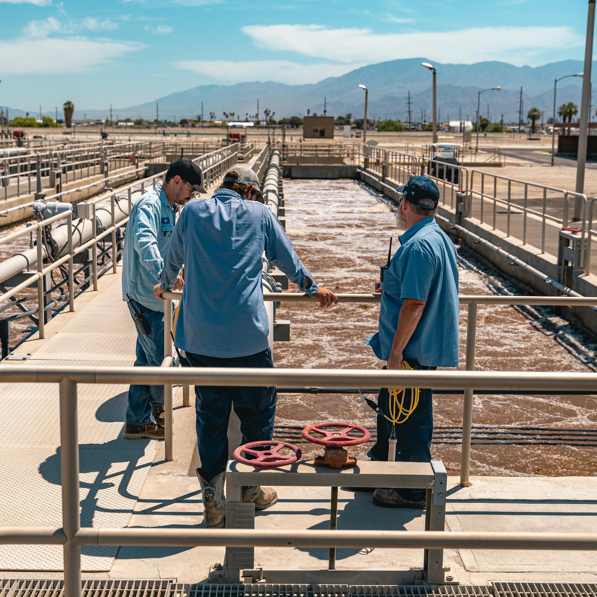 operators standing in front of water treatment