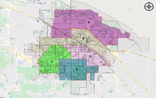 A map divided into five color-coded regions labeled A to E, with roads and geographical details, and a compass in the corner.