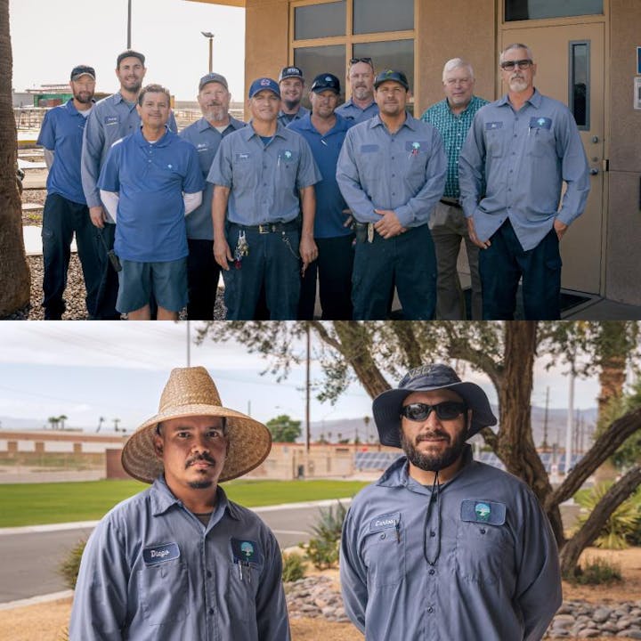 Two groups of workers in uniform, one outside a building, the other in a grassy area, wearing hats and sunglasses.