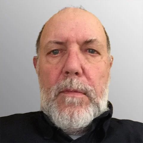 a man with short hair and a grey beard