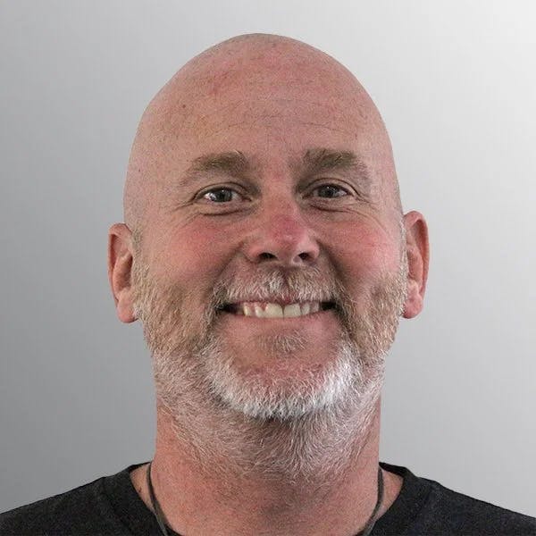 smiling man with short grey beard