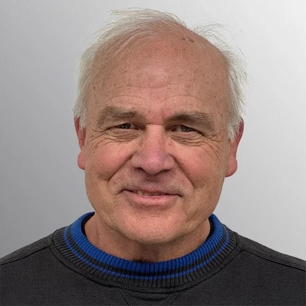 smling man with short white hair