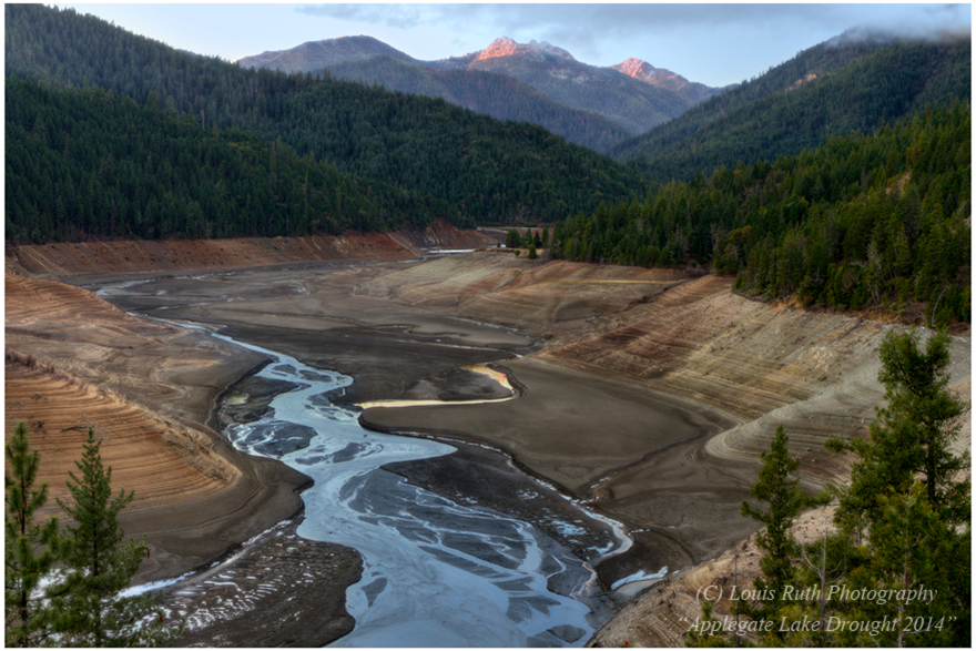 Photo of river flowing through empty reservoir
