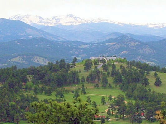 May contain: slope, mountain, mountain range, nature, outdoors, peak, grass, plant, tree, field, vegetation, scenery, countryside, land, and woodland