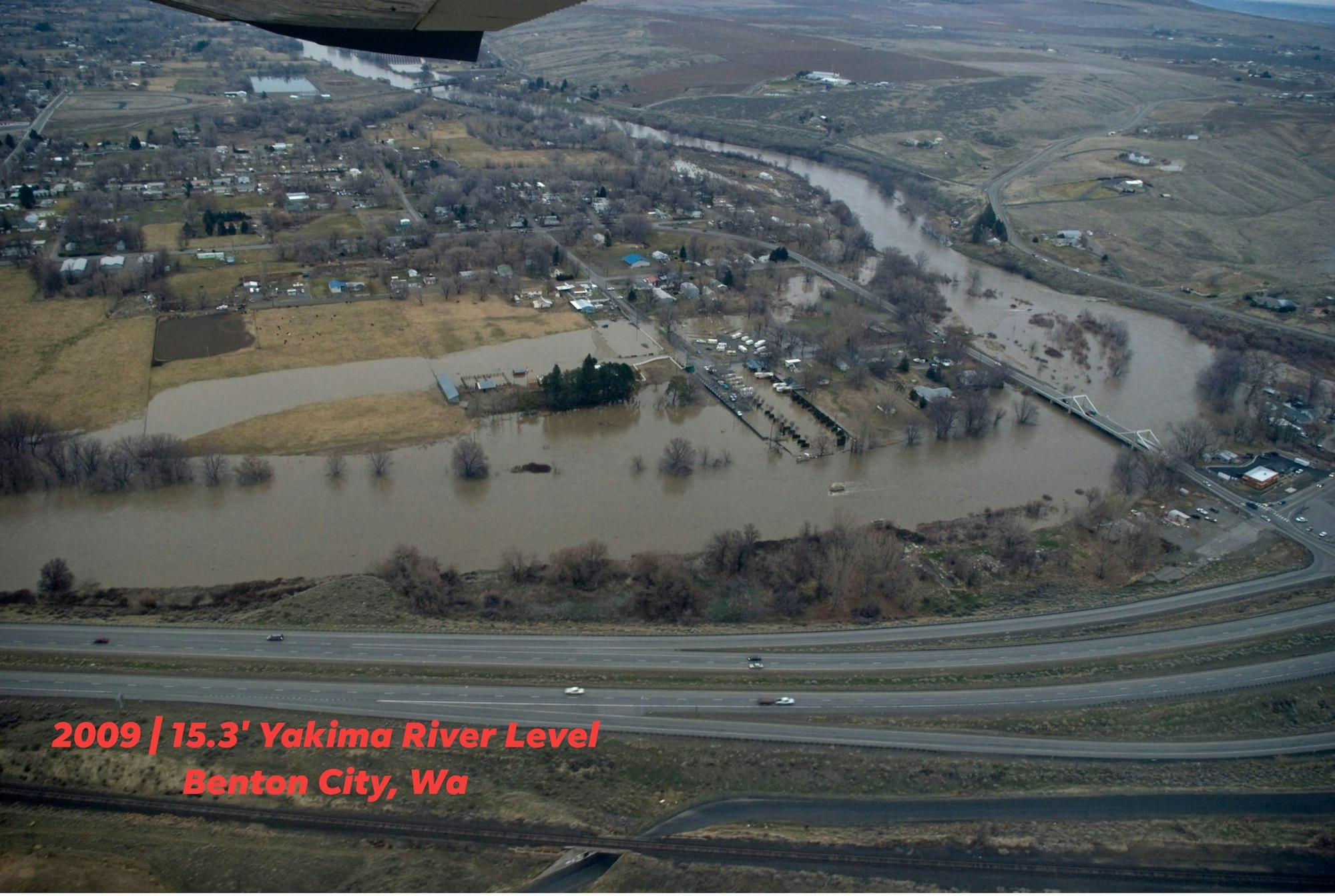 Aerial view of Benton City, WA, showing significant flooding from the Yakima River in 2009, with a river level of 15.3 feet.