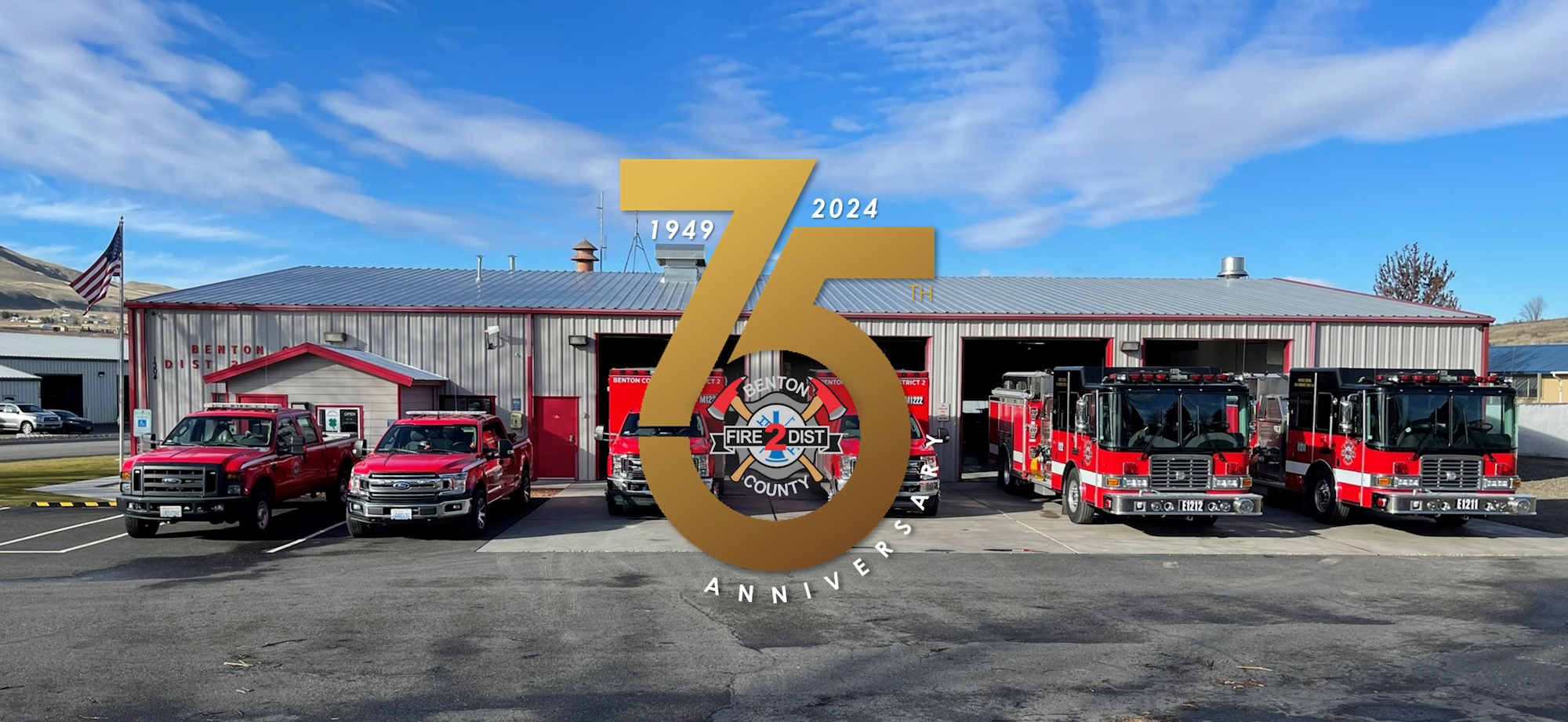 A fire station with trucks, an emblem on the building, and an overlay celebrating an anniversary with years displayed.