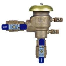 A brass HVAC separator with blue valve handles and a gold cap, used in heating and cooling systems for separating air and impurities.