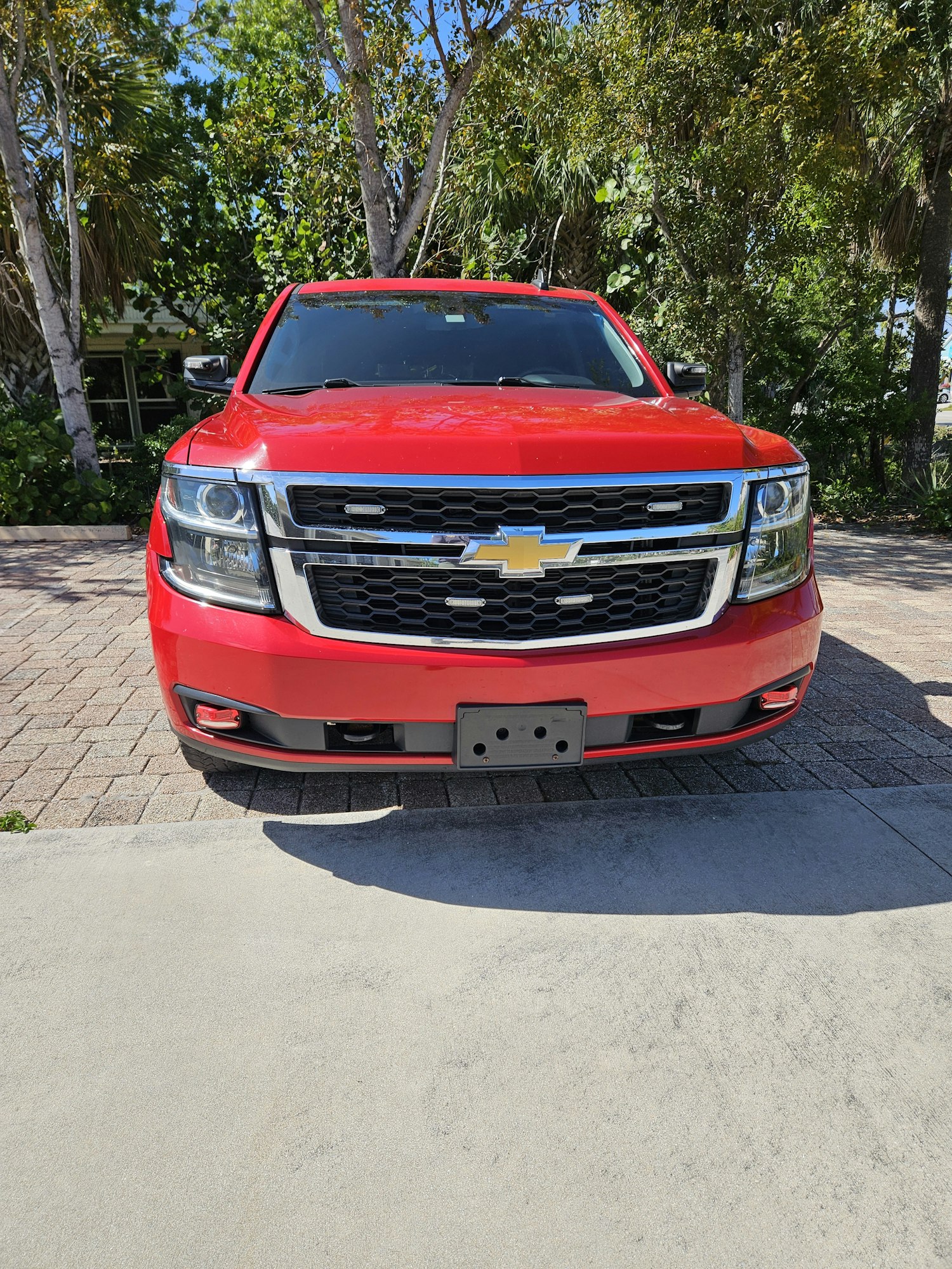 A red Chevrolet pickup truck parked outdoors, image is rotated 90 degrees.