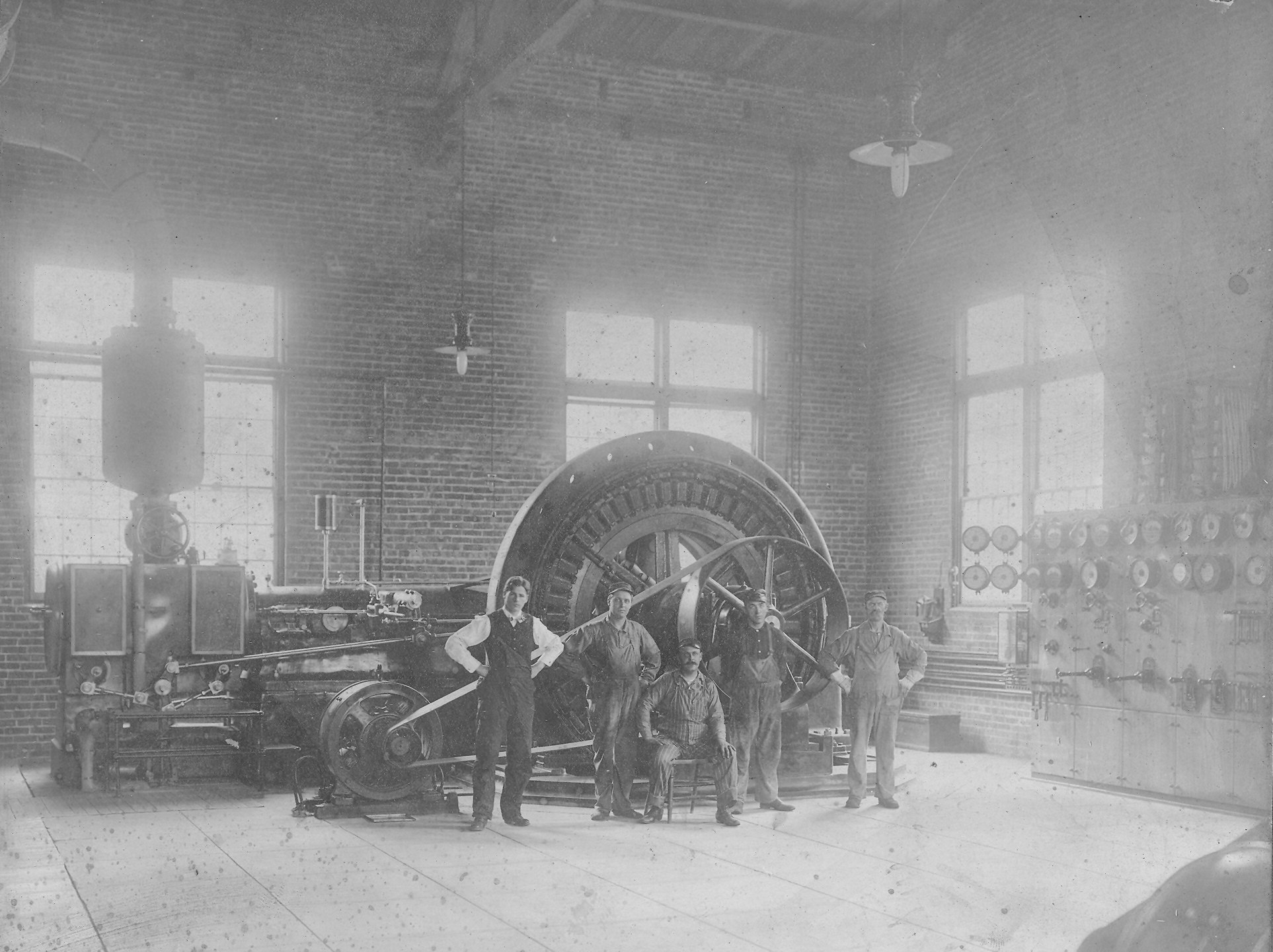 May contain: architecture, building, factory, person, manufacturing, machine, wheel, clothing, footwear, shoe, and glove