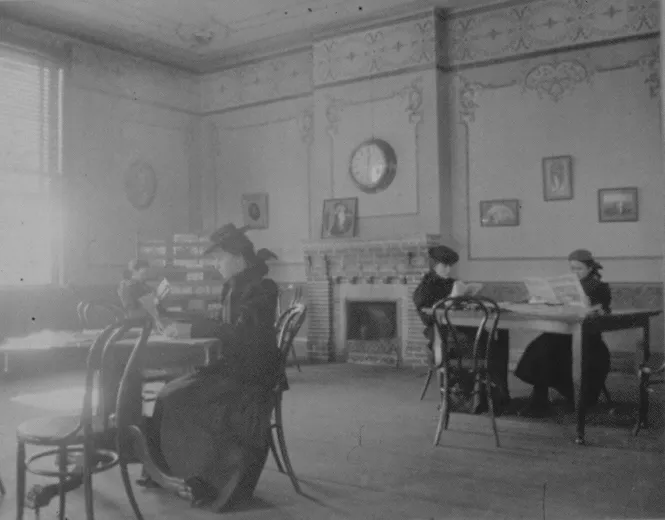 Historical photo of people sitting in a room