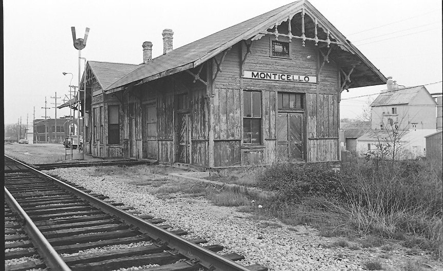 May contain: railway, terminal, train, train station, transportation, vehicle, architecture, building, countryside, hut, nature, outdoors, rural, and car