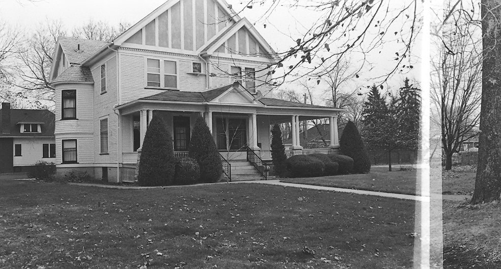 May contain: neighborhood, architecture, building, house, housing, porch, cottage, plant, tree, and grass