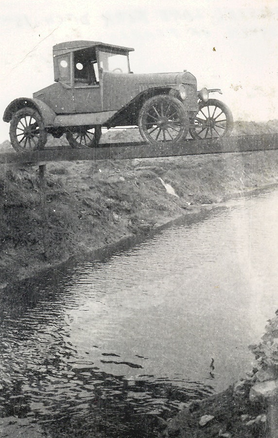 May contain: car, transportation, vehicle, antique car, model t, machine, and wheel