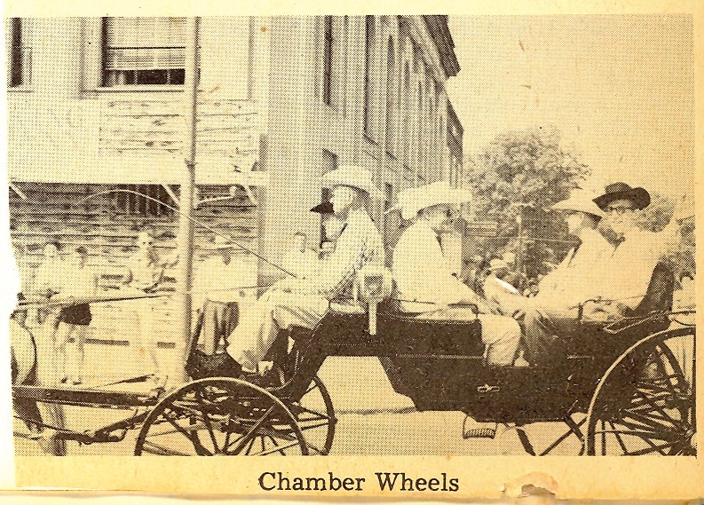 May contain: carriage, transportation, vehicle, person, clothing, hat, machine, and spoke