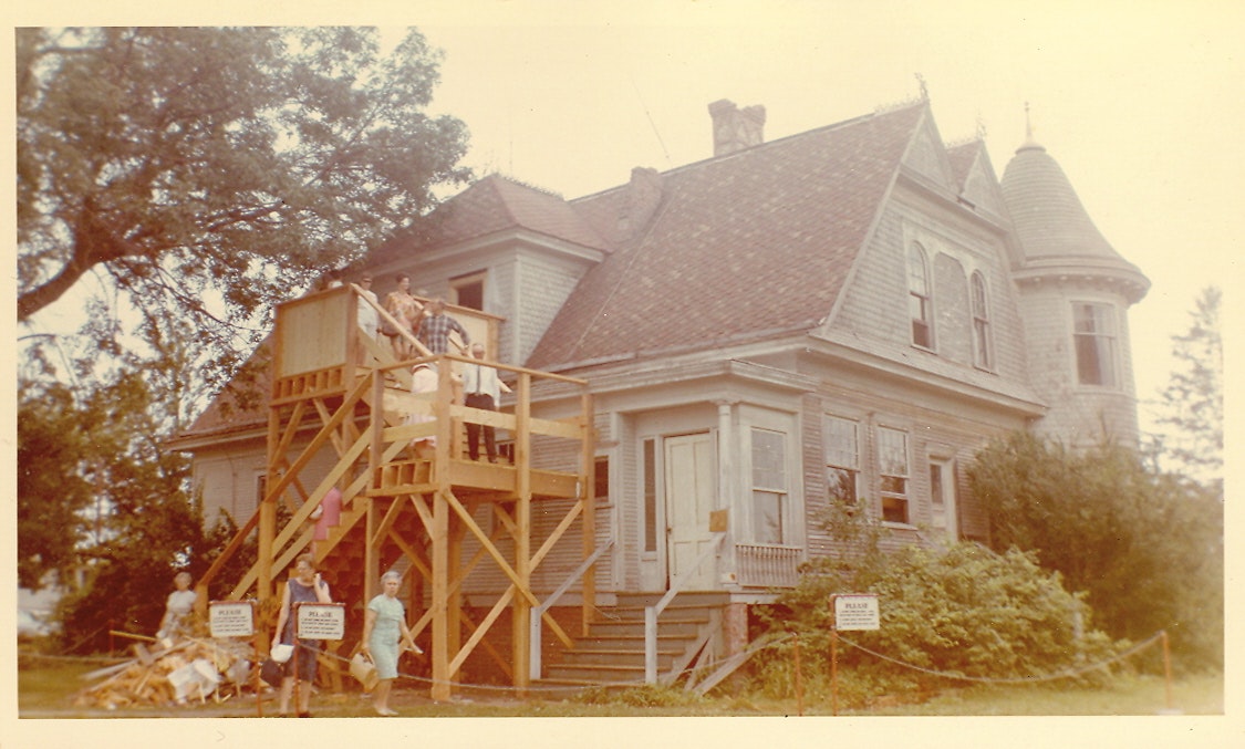 May contain: architecture, building, house, housing, staircase, porch, person, neighborhood, outdoors, and shelter