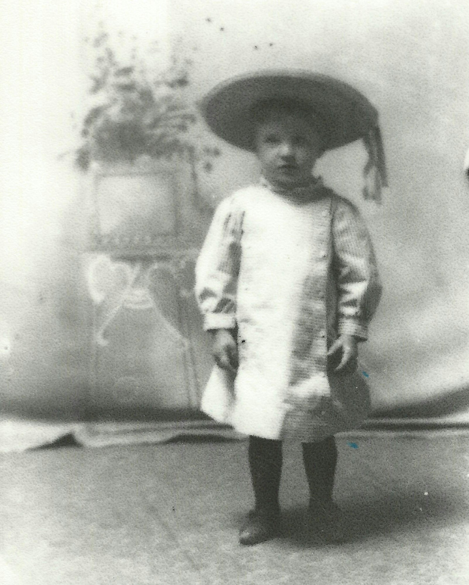 May contain: clothing, hat, coat, boy, child, male, person, photography, face, head, and portrait