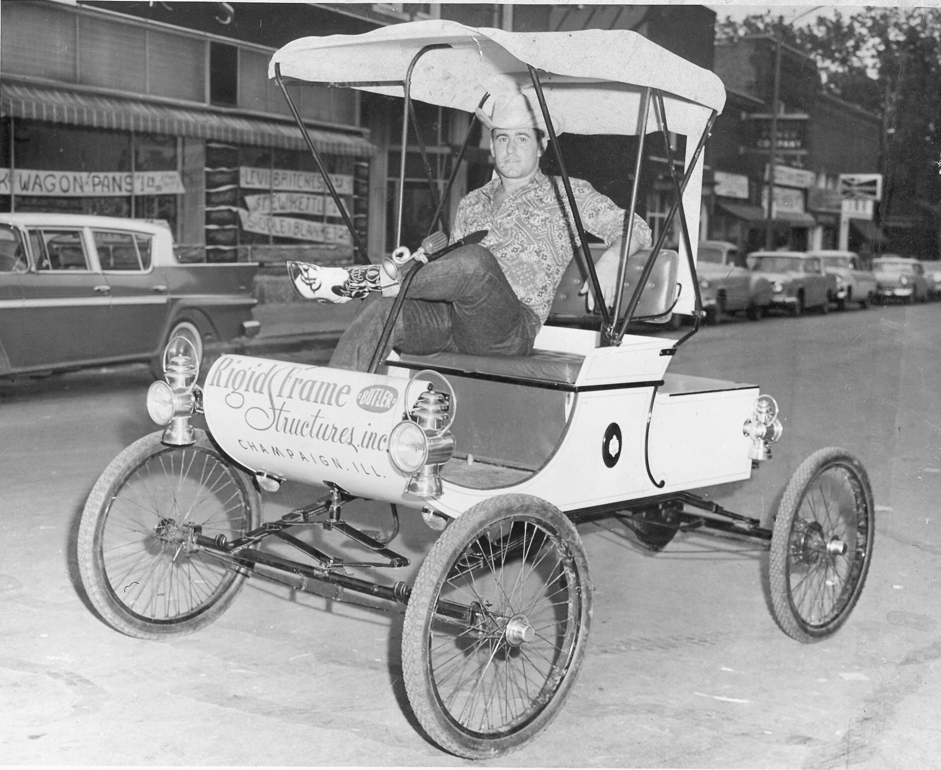 May contain: car, transportation, vehicle, machine, wheel, adult, male, man, person, antique car, model t, and tricycle