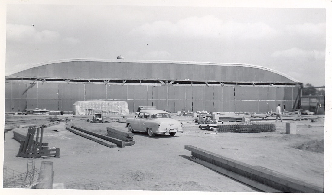 May contain: car, transportation, vehicle, architecture, building, hangar, airport, person, machine, and wheel