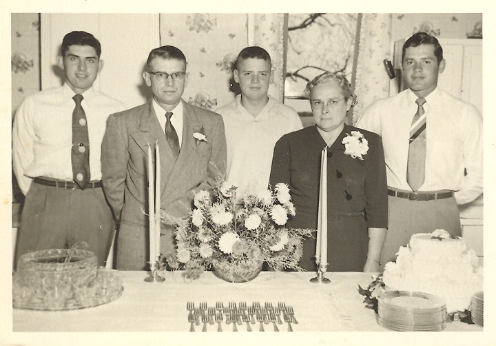 May contain: people, person, flower, flower arrangement, plant, flower bouquet, formal wear, adult, male, man, accessories, tie, clothing, suit, cutlery, fork, dining table, furniture, table, art, floral design, graphics, and pattern