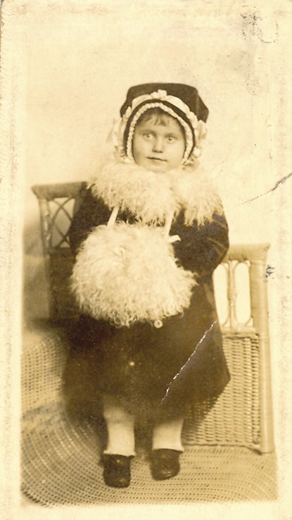 May contain: clothing, hat, bonnet, coat, face, head, person, photography, and portrait