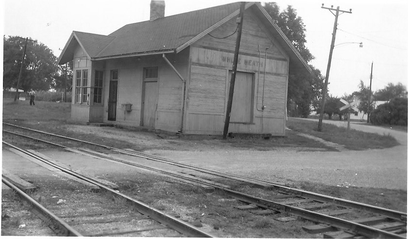 May contain: railway, terminal, train, train station, transportation, vehicle, person, architecture, building, countryside, hut, nature, outdoors, and rural