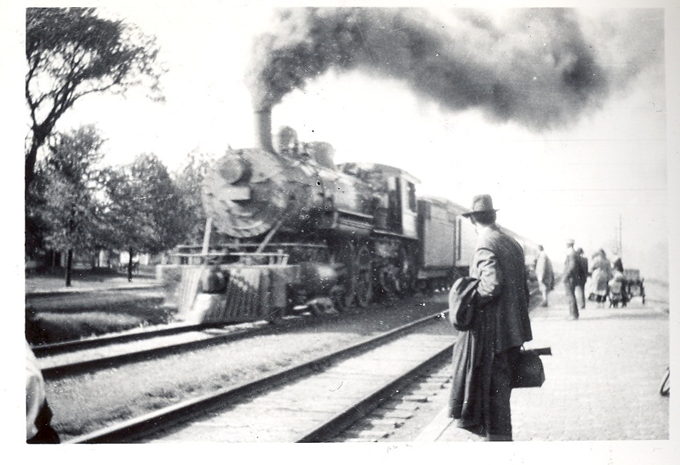 May contain: locomotive, railway, train, transportation, vehicle, clothing, coat, person, engine, machine, motor, and steam engine