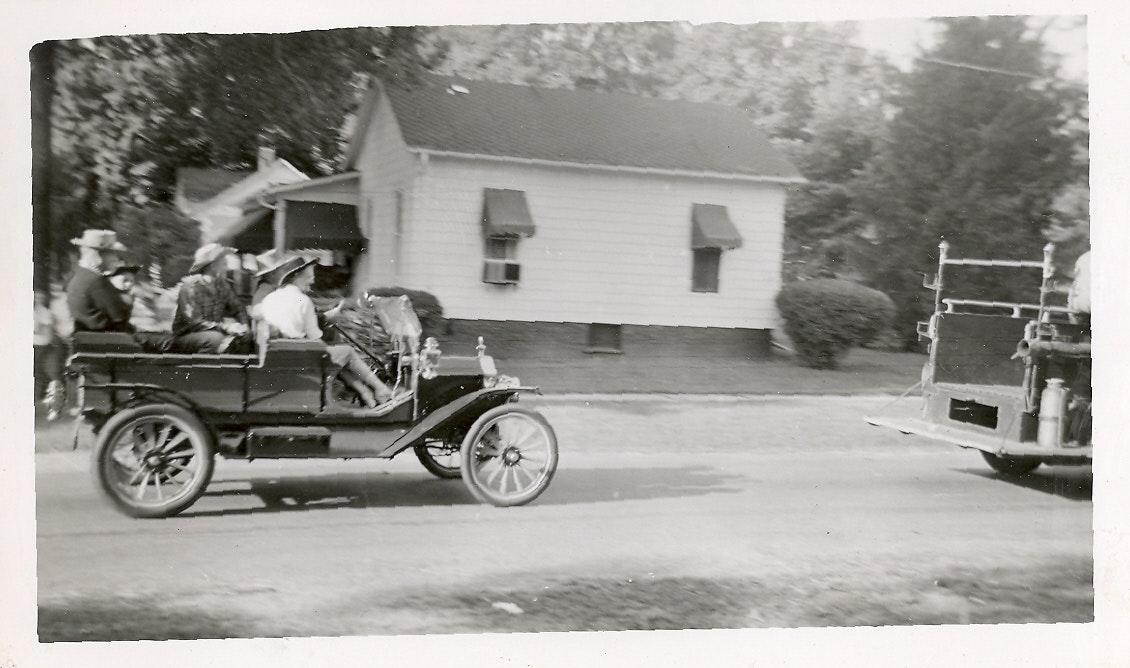 May contain: machine, spoke, antique car, car, model t, transportation, vehicle, wheel, and person
