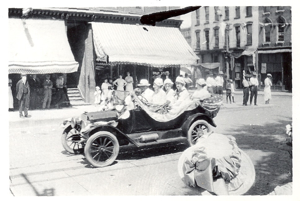 May contain: antique car, car, model t, transportation, vehicle, machine, wheel, and person