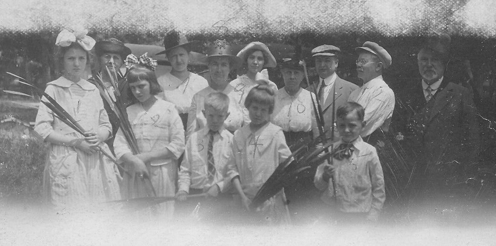 May contain: people, person, adult, male, man, accessories, formal wear, tie, firearm, gun, rifle, weapon, clothing, hat, and glove
