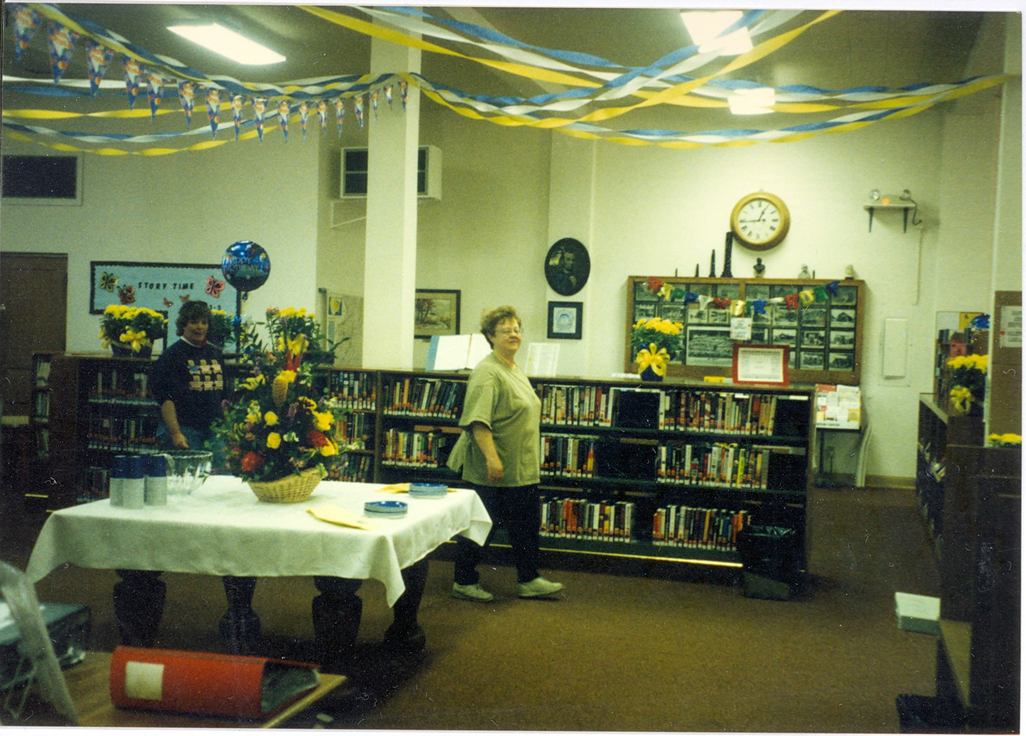 May contain: book, publication, indoors, library, architecture, building, adult, male, man, person, furniture, and table