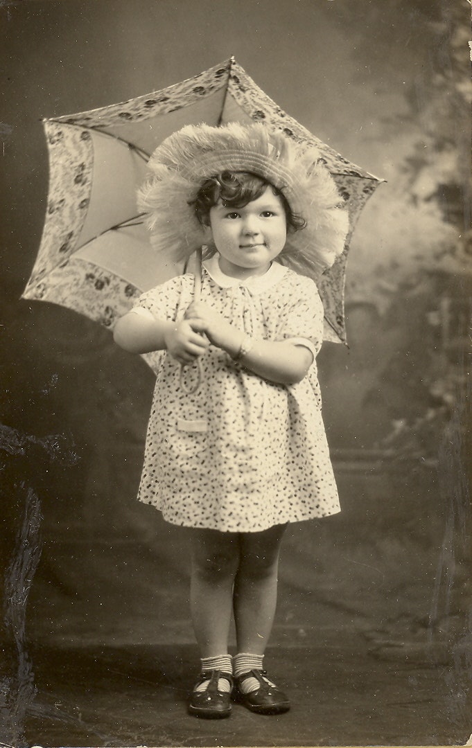 May contain: clothing, hat, face, head, person, photography, portrait, footwear, sandal, bonnet, dress, and shoe