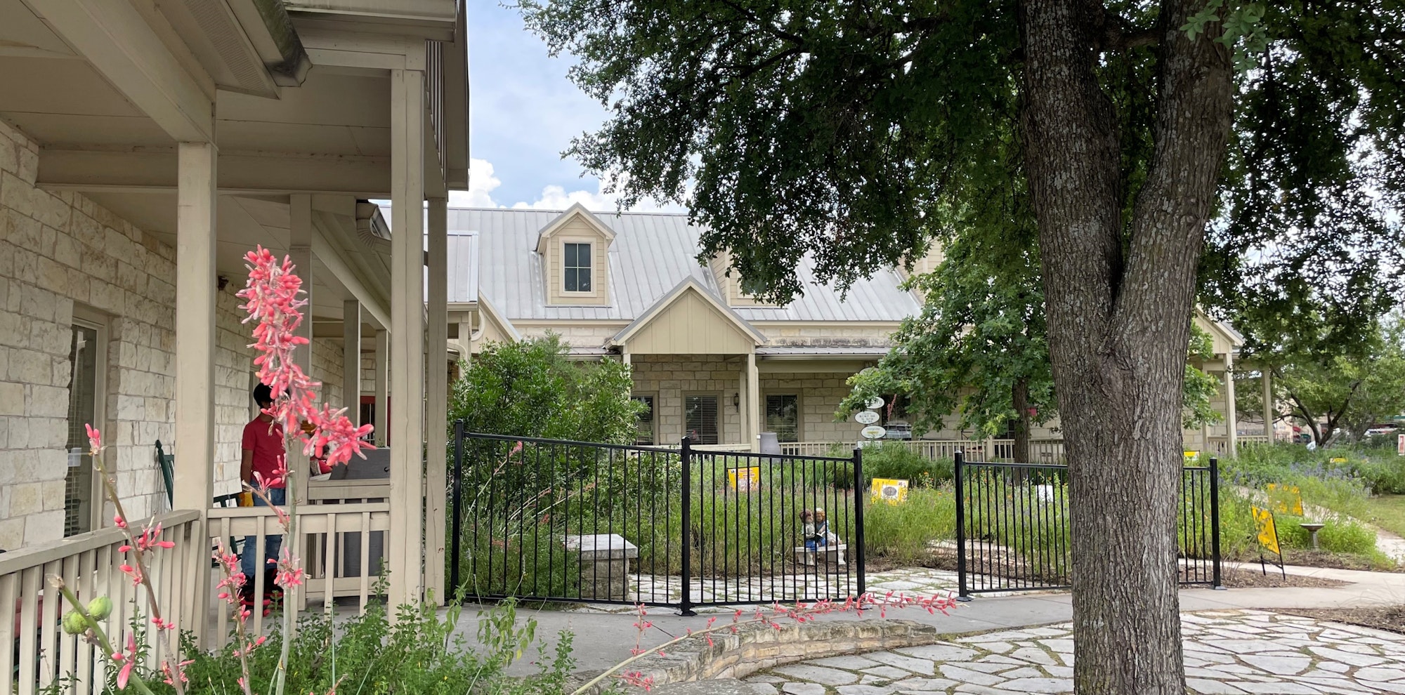 May contain: neighborhood, path, walkway, person, outdoors, nature, yard, garden, architecture, building, housing, scenery, city, plant, and tree