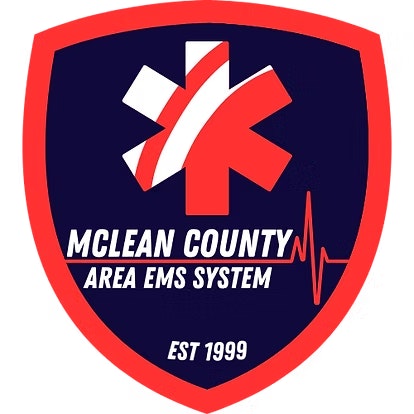 Shield-shaped logo with a star, heart rate line, and text: "McLean County Area EMS System, Est 1999."
